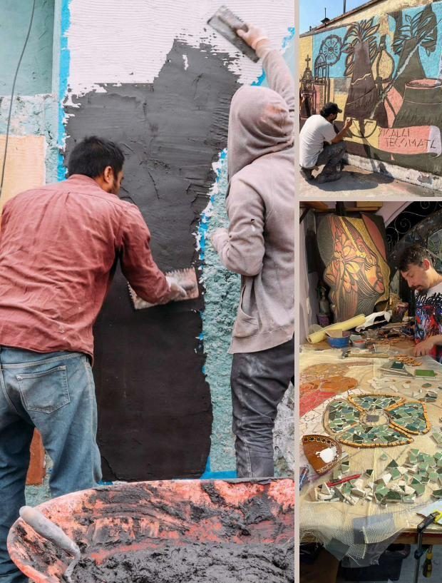 Participantes trabajan en un muro